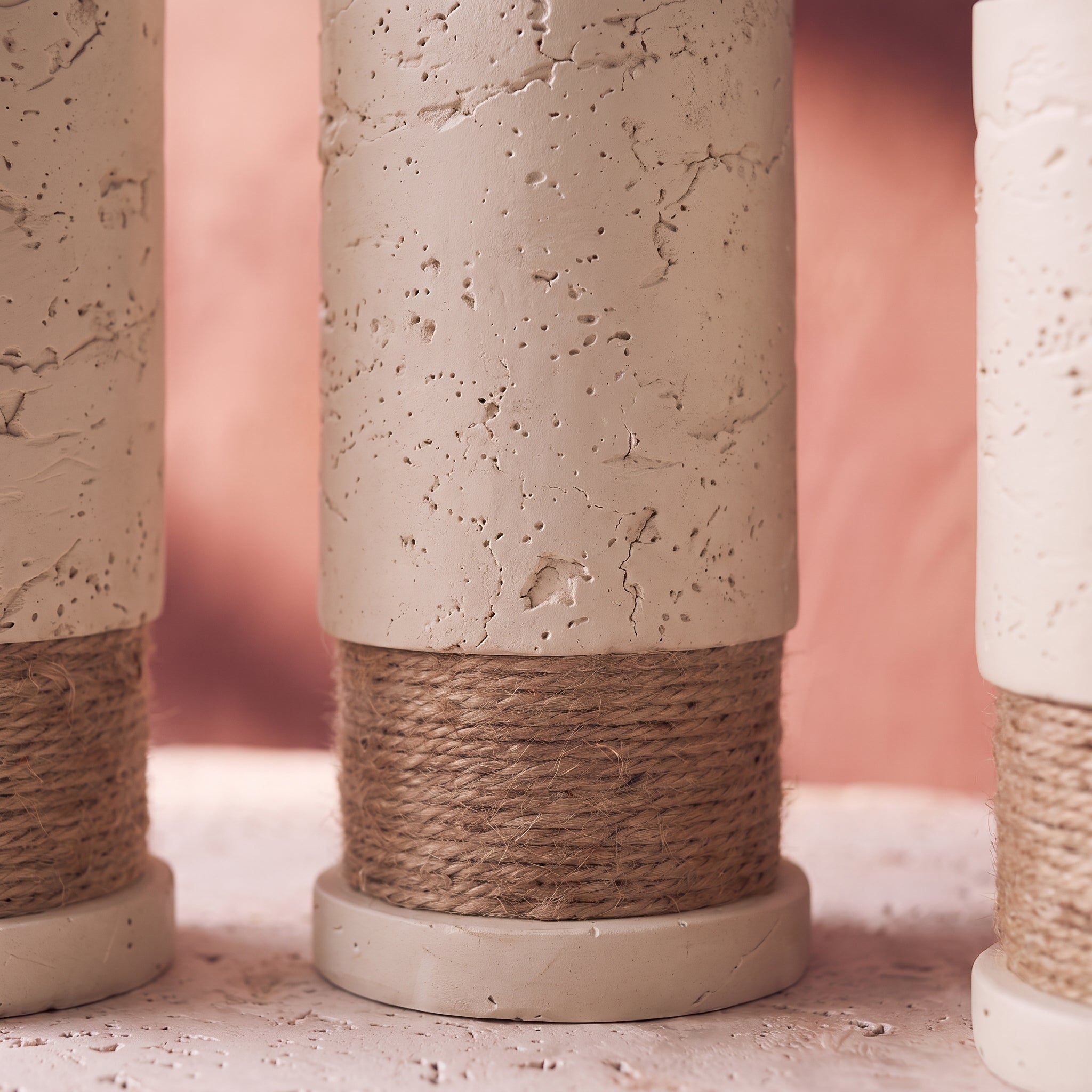 Rustic Column Trio close-up: cracked plaster texture, jute twine band and disc foot of the tall piece