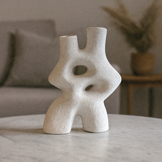 Abstract Pottery sculpture on a marble surface with a blurred indoor background