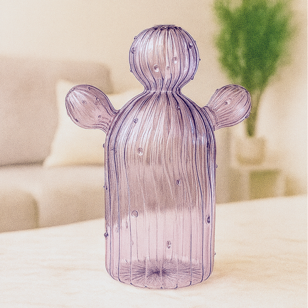 Purple glass cactus-shaped lamp on a table with a blurred background