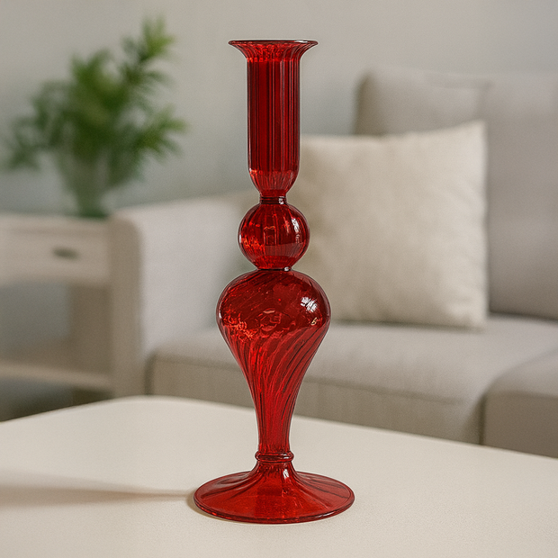 Red glass Candle holder on a white surface with a blurred background