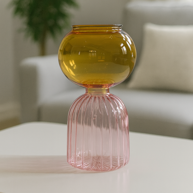 Two-toned glass vase on a table with a blurred indoor background