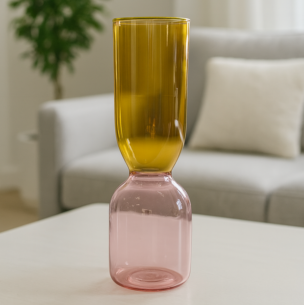 Two-toned glass vase on a table with a blurred indoor background