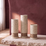Rustic Column Trio: three ivory textured plaster candle holders with jute twine bands, 17, 20 and 12 cm, on a stone slab